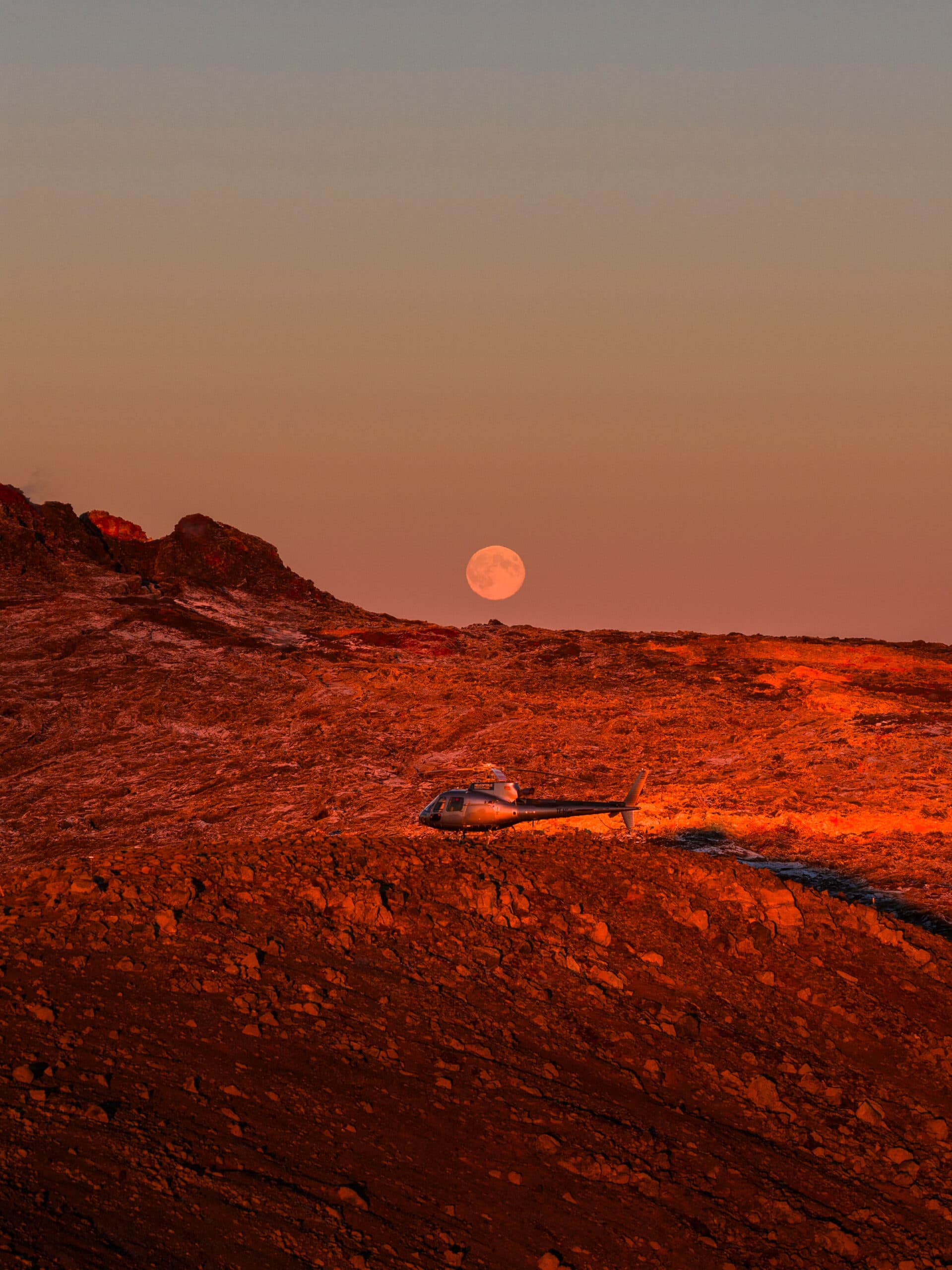 Helicopter flying over a mountain range