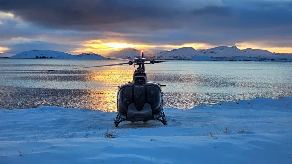 Person taking picture in a helicopter